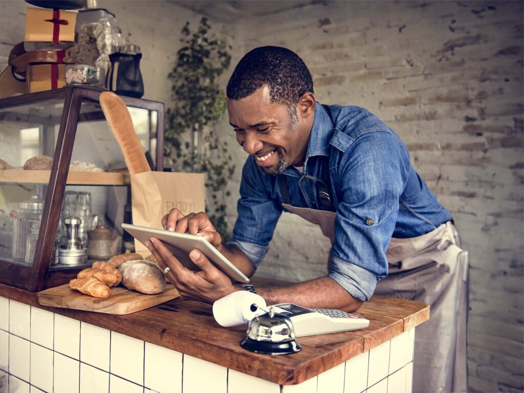 A limited company owner on his tablet in his shop using the ONP Solicitor's website