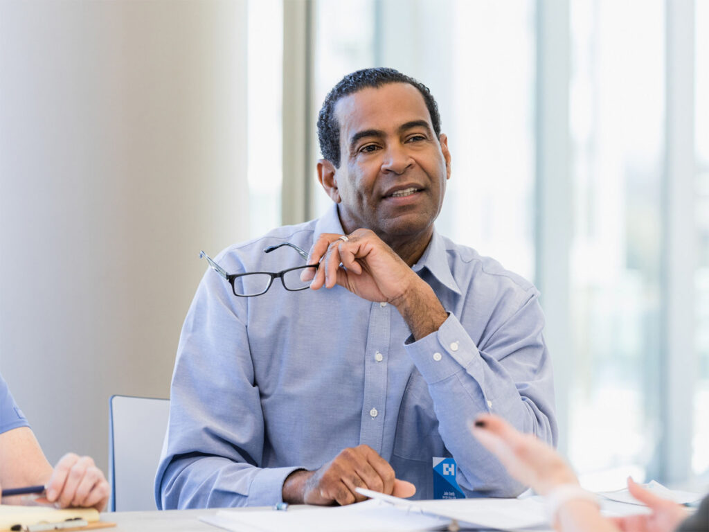 A broker or lender in the conveyancing industry sitting in a business meeting with ONP Solicitors