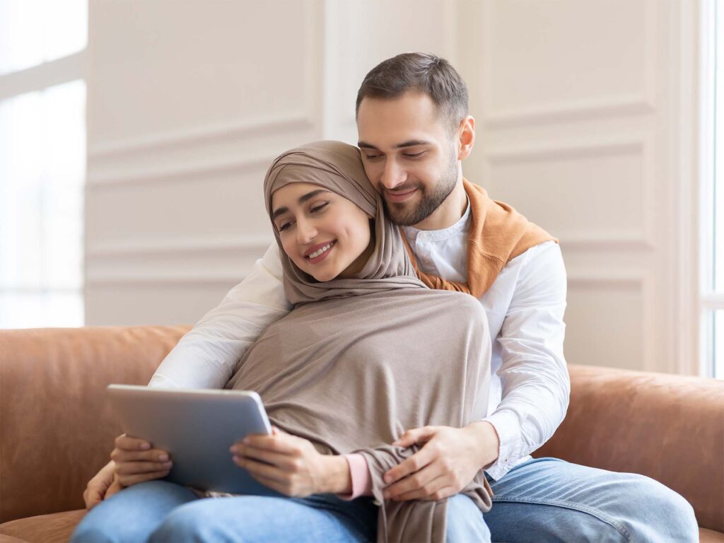 A couple on a tablet arranging their remortgage with help from ONP Solicitors legal team