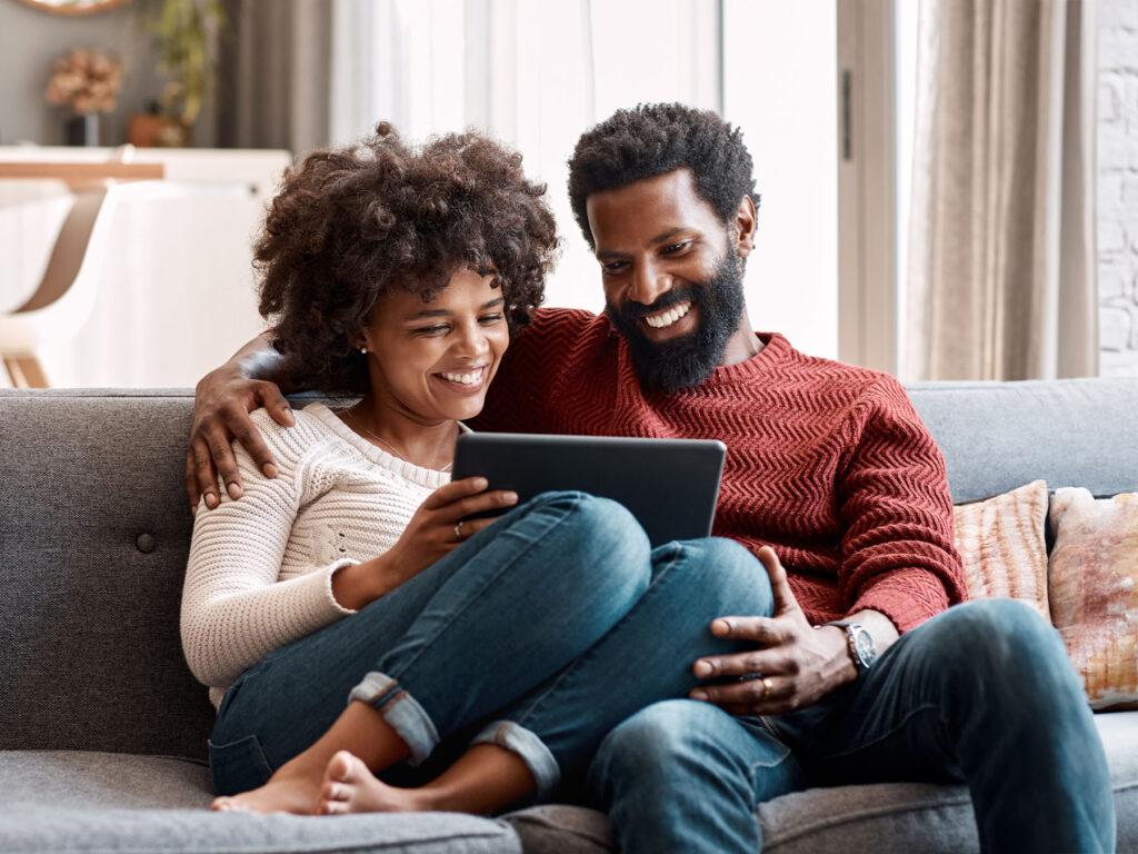 A couple on a tablet obtaining a quote from ONP Solicitors for home buying legal services